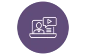 A purple circle with a white outline icon of a person in front of a computer screen. The screen shows a play button and lines representing text.