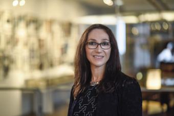 Headshot of Maria Elena Bottazzi, Sr. Associate Dean of the National School of Tropical Medicine at Baylor College of Medicine. A woman with long, dark hair wearing glasses in a dark blazer and top smiling at the camera.