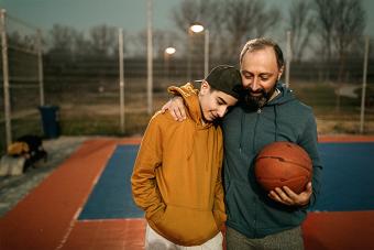 father and son hugging after playing basketball-Screener thumbnail