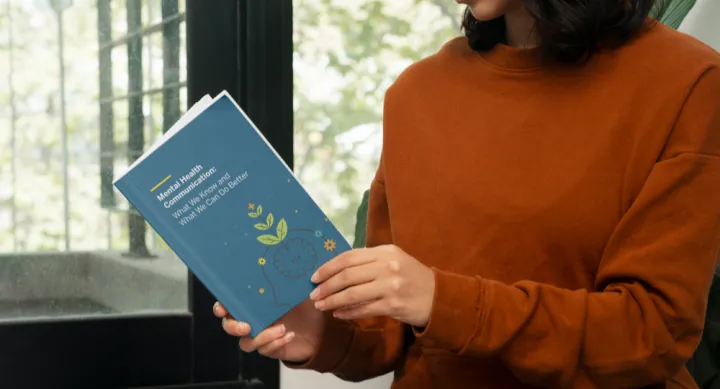 woman reading white paper on mental health communication