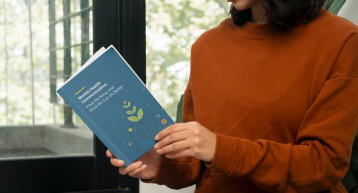 woman reading white paper on mental health communication 