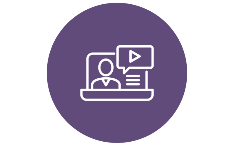 A purple circle with a white outline icon of a person in front of a computer screen. The screen shows a play button and lines representing text.